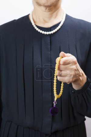 Photo for Woman in a mourning dress with prayer beads - Royalty Free Image