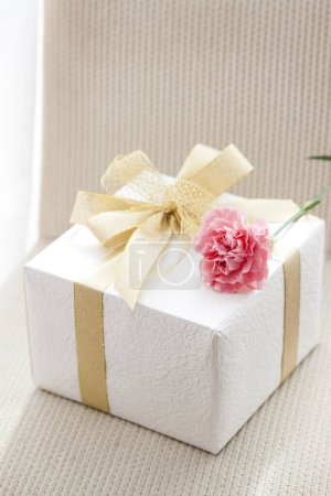 Photo for Gift box with pink flower on background, close up - Royalty Free Image