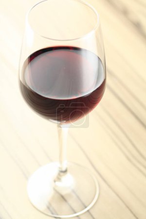 Photo for Glass of red wine on a wooden table, close-up - Royalty Free Image