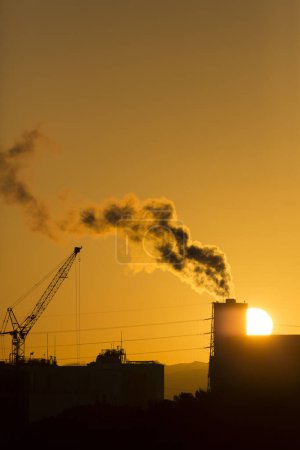 Photo for Silhouette of a factory with a sunset on nature background - Royalty Free Image