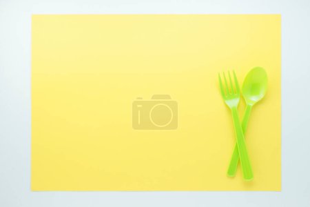 Photo for Top view of bright plastic cutlery on yellow background - Royalty Free Image