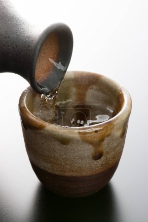 Photo for Close-up of pouring Japanese liquor - Royalty Free Image