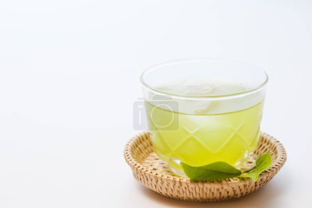 Photo for Traditional matcha tea with leaves on background - Royalty Free Image