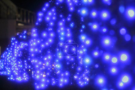 Photo for Blurred festive background with bright lights and christmas decorations in night city - Royalty Free Image