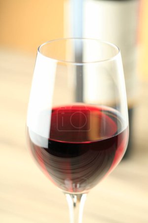 Photo for Glass of red wine on a wooden table, close-up - Royalty Free Image