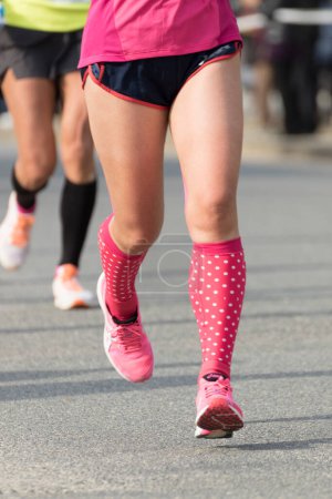 Photo for Legs of athletes jogging in motion blur, low section - Royalty Free Image