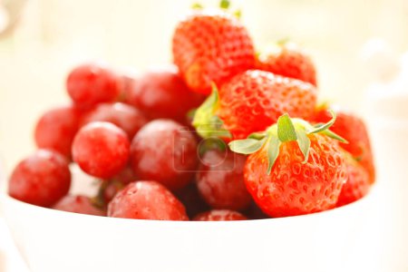 Photo for Grapes and strawberries on table - Royalty Free Image