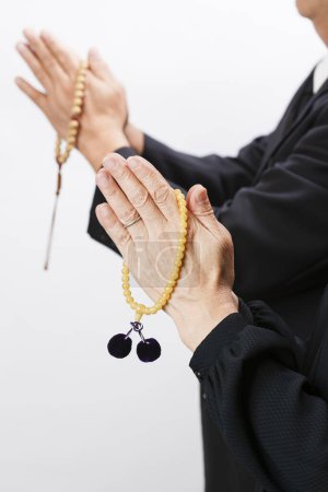 Photo for Women in black clothes holding rosary beads, close - up - Royalty Free Image