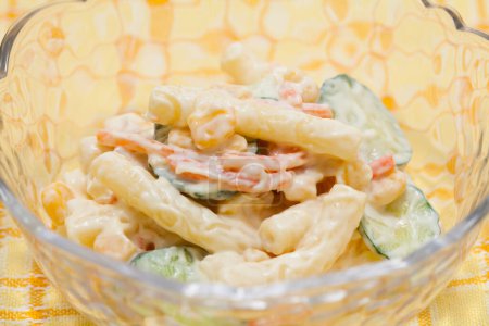 Photo for Pasta salad with corn, cucumbers and carrots - Royalty Free Image