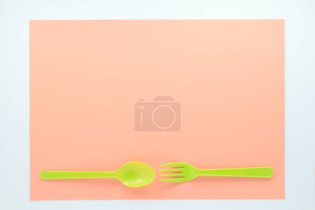Photo for Top view of bright plastic cutlery on red background - Royalty Free Image