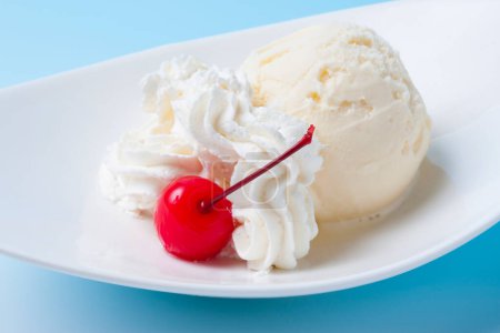 Photo for Vanilla ice cream in a glass with cherry and ice cream. - Royalty Free Image