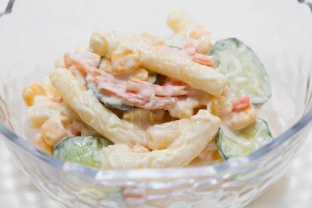 Photo for Pasta salad with corn, cucumbers and carrots - Royalty Free Image