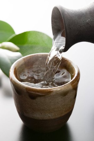 Photo for Close-up of pouring Japanese liquor - Royalty Free Image