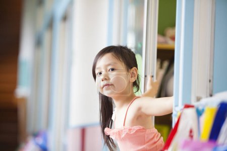 Photo for Asian little girl looking at the camera in classroom - Royalty Free Image