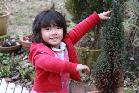 Photo for Portrait of little asian girl posing outdoors - Royalty Free Image