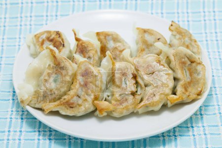 tasty Japanese gyoza or dumplings on background