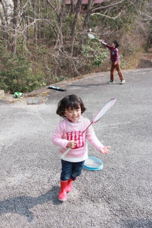 Photo for Cute little Asian girl playing badminton - Royalty Free Image