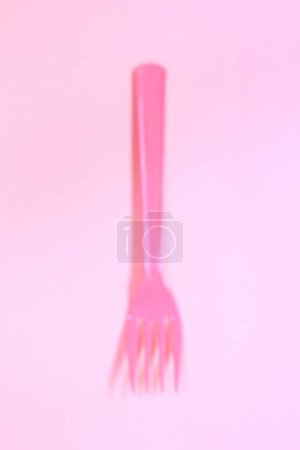Photo for Top view of bright plastic fork on pink background - Royalty Free Image