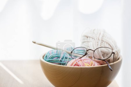 Photo for Knitting yarns and knitting needles in a wooden bowl - Royalty Free Image