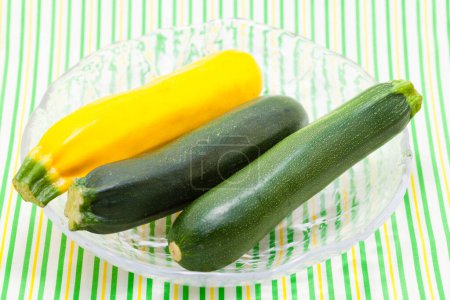 Photo for Raw fresh zucchinis in glass bowl - Royalty Free Image