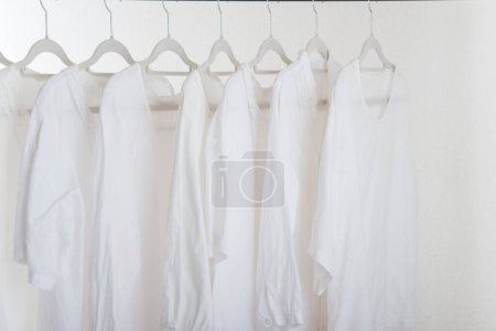 Photo for A rack of white shirts hanging on a wall - Royalty Free Image