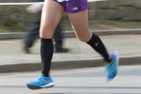 Photo for Legs of athlete jogging in motion blur, low section - Royalty Free Image