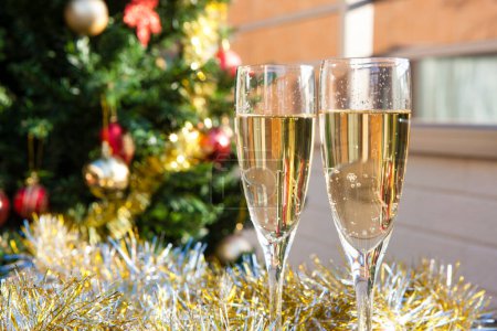Photo for Glasses of champagne and festive christmas decorations, close-up - Royalty Free Image