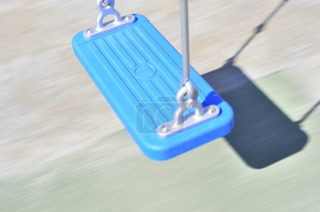 Photo for Empty blue swing at the playground - Royalty Free Image