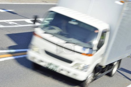 Téléchargez les photos : Grand camion blanc conduisant sur la route, flou de mouvement - en image libre de droit