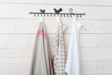 Photo for Towels on hangers on the wooden background, close up - Royalty Free Image