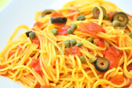 Photo for Delicious italian pasta with salmon pieces and olives - Royalty Free Image
