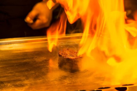 Photo for Chef cooking beef on a fire on background, close up - Royalty Free Image