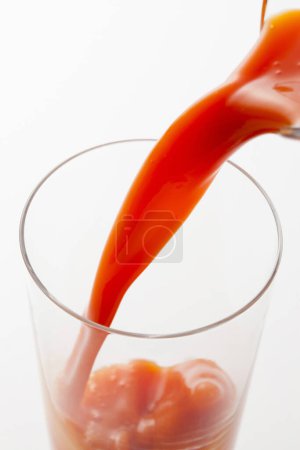 Photo for A glass of red tomato juice on background, close up - Royalty Free Image