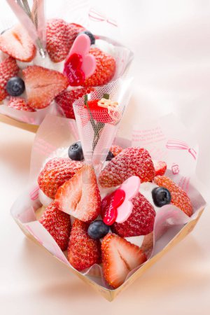 Photo for Close-up view of delicious mothers day desserts with tasty berries - Royalty Free Image