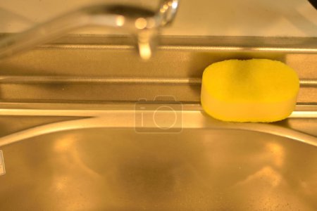 Photo for Yellow sponge in the sink close-up view - Royalty Free Image