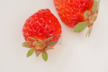 Photo for Two red strawberries on white background - Royalty Free Image