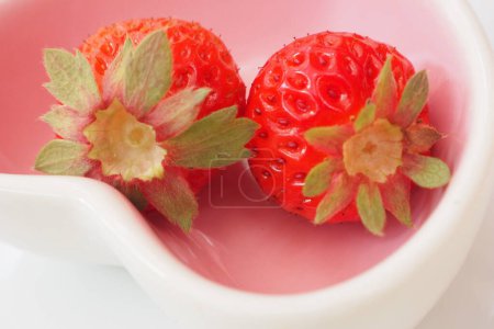 Photo for Two red strawberries on white bowl - Royalty Free Image