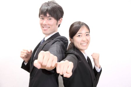 Foto de Exitoso asiático hombre de negocios y mujer de negocios con puños levantados sobre fondo blanco - Imagen libre de derechos
