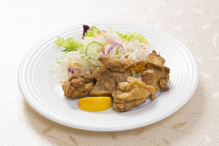 Photo for Close-up view of fried chicken pieces and vegetable salad on white dish - Royalty Free Image