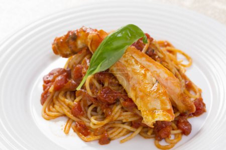 Photo for Close-up view of spaghetti with tomato sauce and basil on white plate - Royalty Free Image