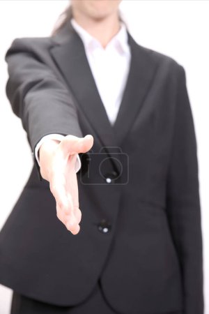 Foto de El hombre de negocios con traje extiende su mano para darle la mano. Aislado sobre fondo blanco - Imagen libre de derechos
