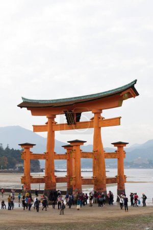 Photo for Floating Torii gate of Itsukushima shrine temple and tourists in Miyajima, Japan - Royalty Free Image