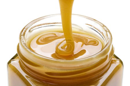 Photo for Close-up view of sweet fresh honey isolated over white background - Royalty Free Image