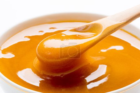 Photo for Close-up view of sweet fresh honey isolated over white background - Royalty Free Image