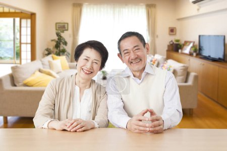 Téléchargez les photos : Couple japonais senior dans le salon à la maison - en image libre de droit