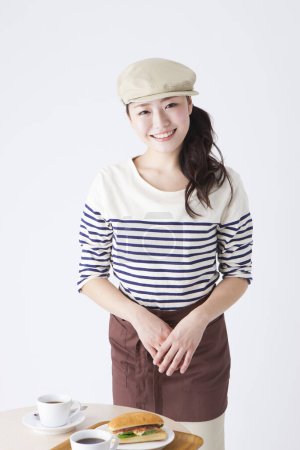 Photo for Portrait of beautiful young japanese waitress in stylish clothes at cafeteria - Royalty Free Image