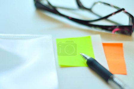 Téléchargez les photos : Notes collantes colorées avec stylo sur fond de table blanche - en image libre de droit