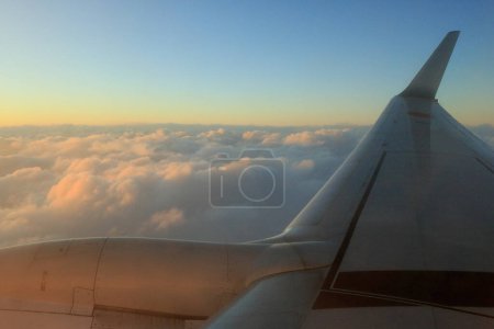 Téléchargez les photos : Vue depuis la fenêtre de l'avion, nuages couchant dans le ciel - en image libre de droit