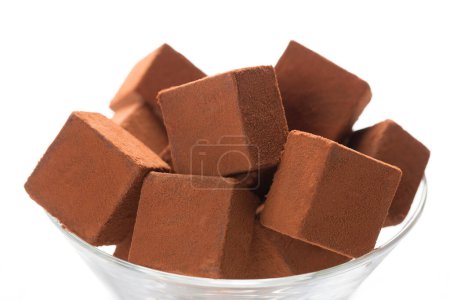 Photo for Pile of chocolate cubes on a white surface - Royalty Free Image