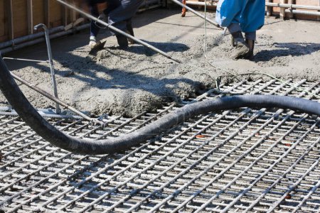 Photo for Worker pouring cement for making floor at construction site - Royalty Free Image